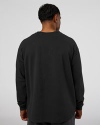 Man wearing Classic Heavyweight FLXCotton Oversized Long Sleeve Tee - Washed Black-Black | Model:Xav | Size:L