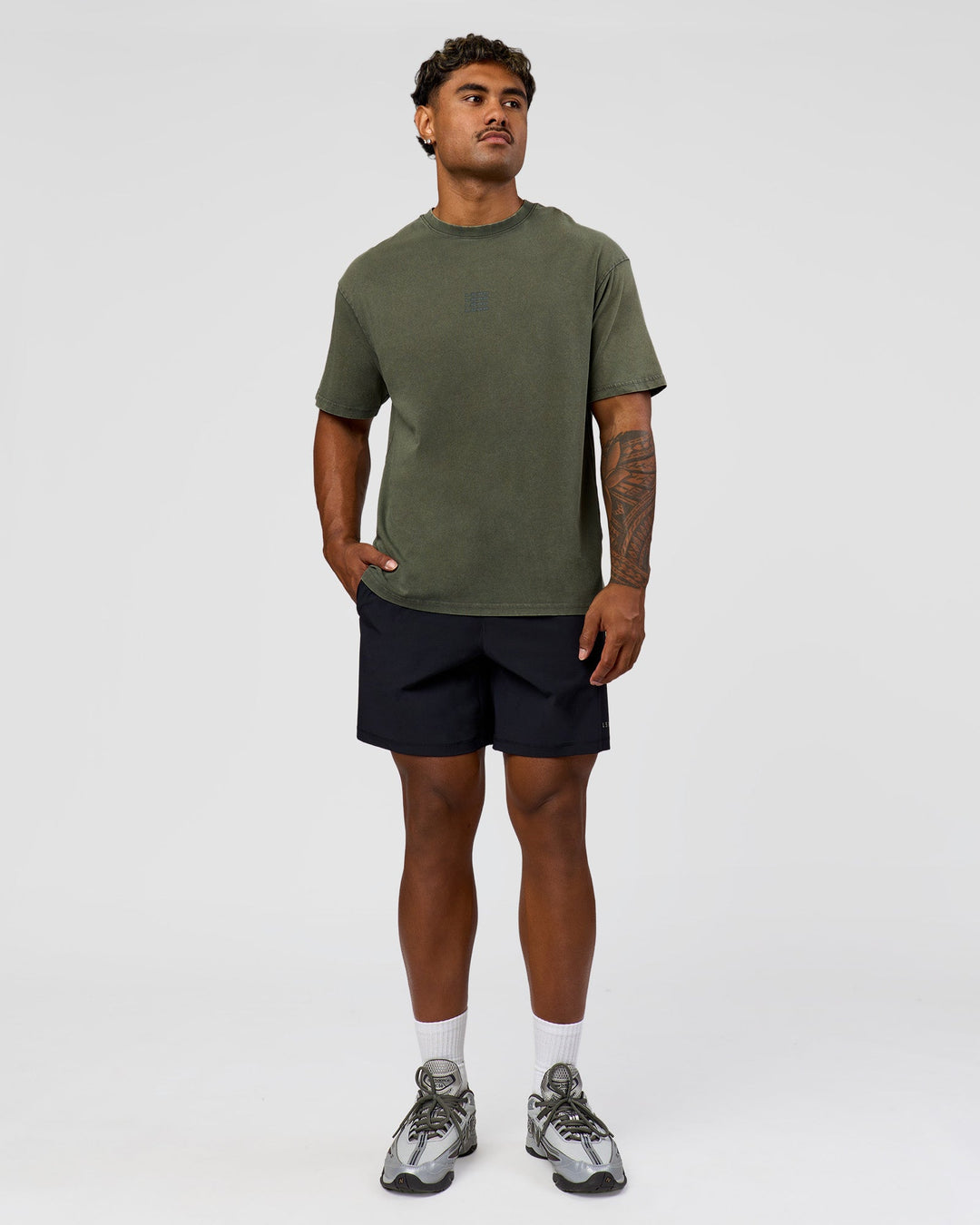 Man wearing Everyday Elevation FLXCotton Oversized Tee - Carbon Green Washed -White | Model:Xav | Size:L