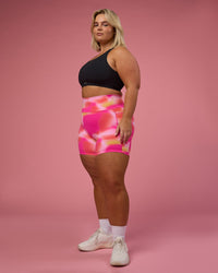 Woman wearing Fusion Ultra High-Rise 6" Short Pockets - Pink Glow Print | Model:Bianca | Size:L