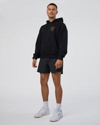 Man wearing GTC CVC Fleece Unisex Oversized Hoodie - Black-Cantaloupe | Model:Nikola | Size:L