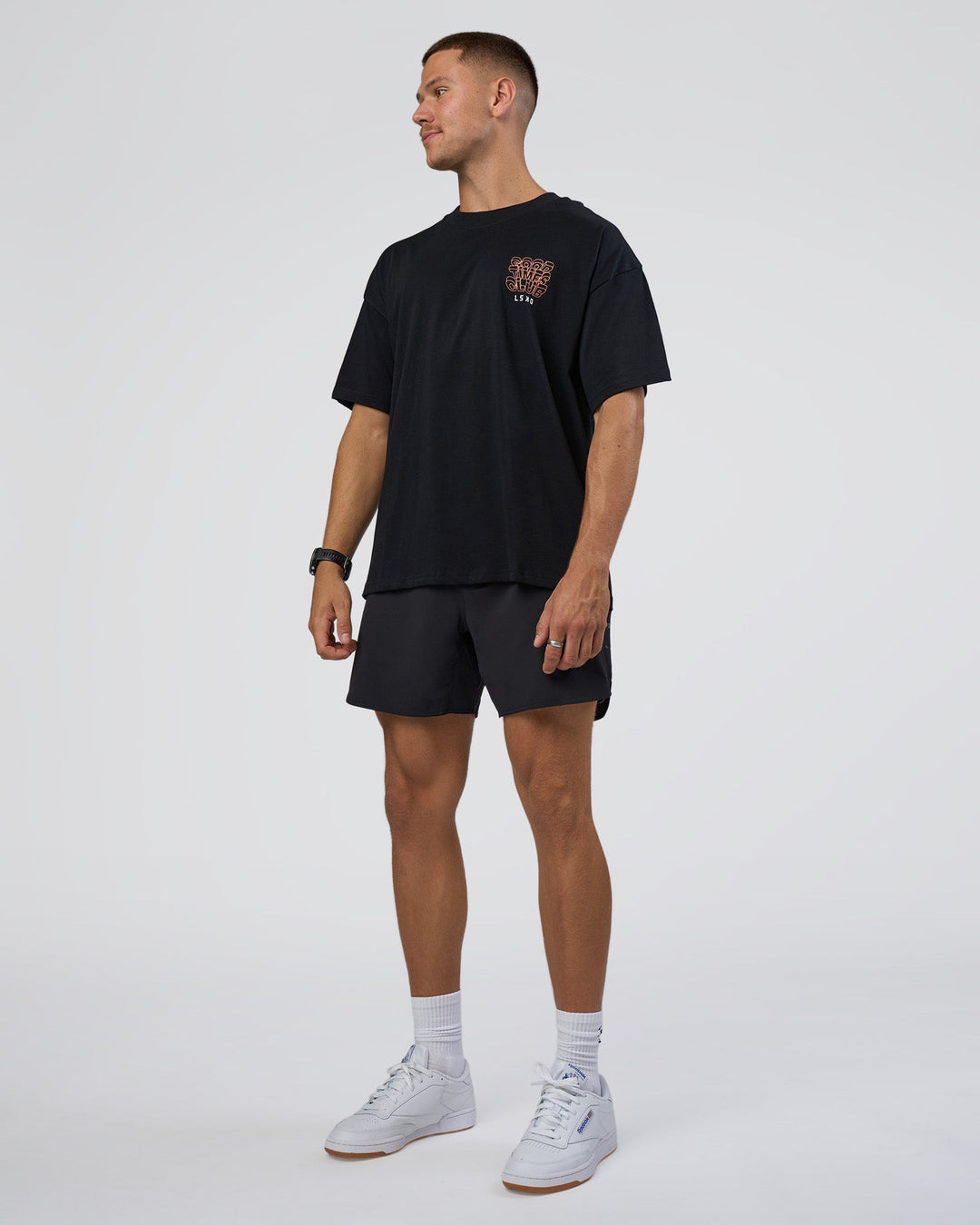Man wearing GTC Heavyweight Oversized Tee - Black-Cantaloupe | Model:Nikola | Size:L