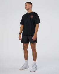 Man wearing GTC Heavyweight Oversized Tee - Black-Cantaloupe | Model:Nikola | Size:L