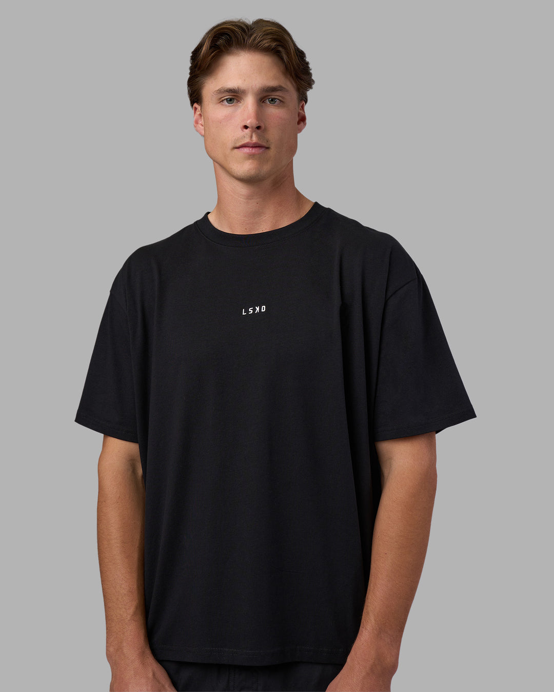 Man wearing Go-To FLXCotton Oversized Tee - Black-White | Model:Brandon | Size:L
