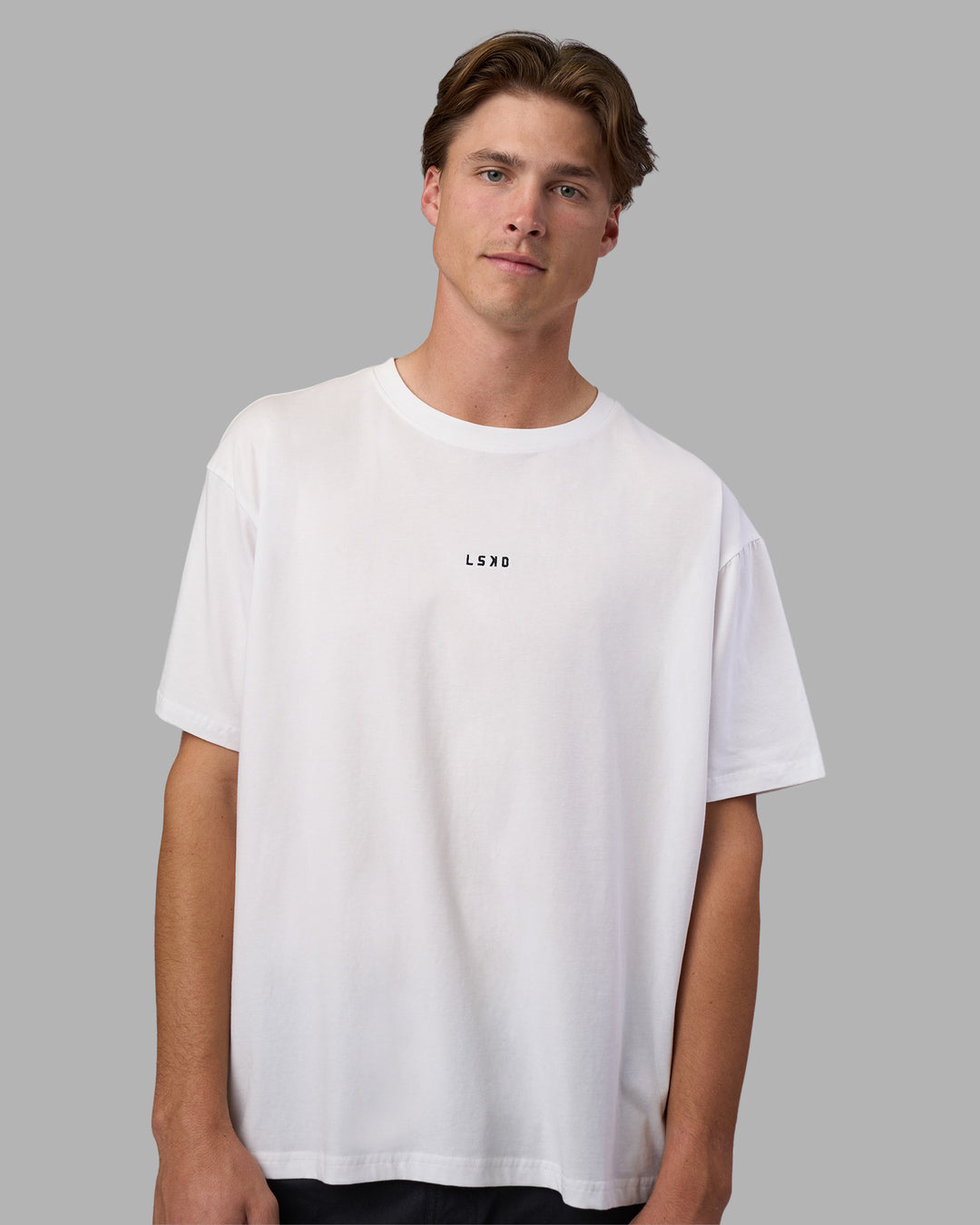 Man wearing Go-To FLXCotton Oversized Tee - White-Black | Model:Brandon | Size:L
