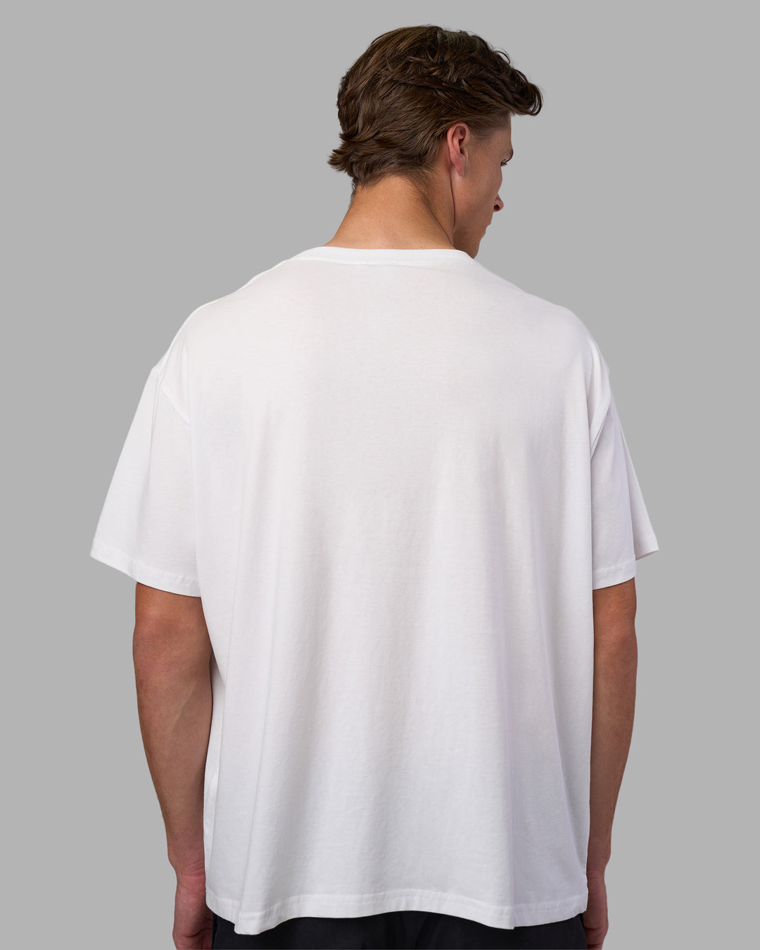 Man wearing Go-To FLXCotton Oversized Tee - White-Black | Model:Brandon | Size:L
