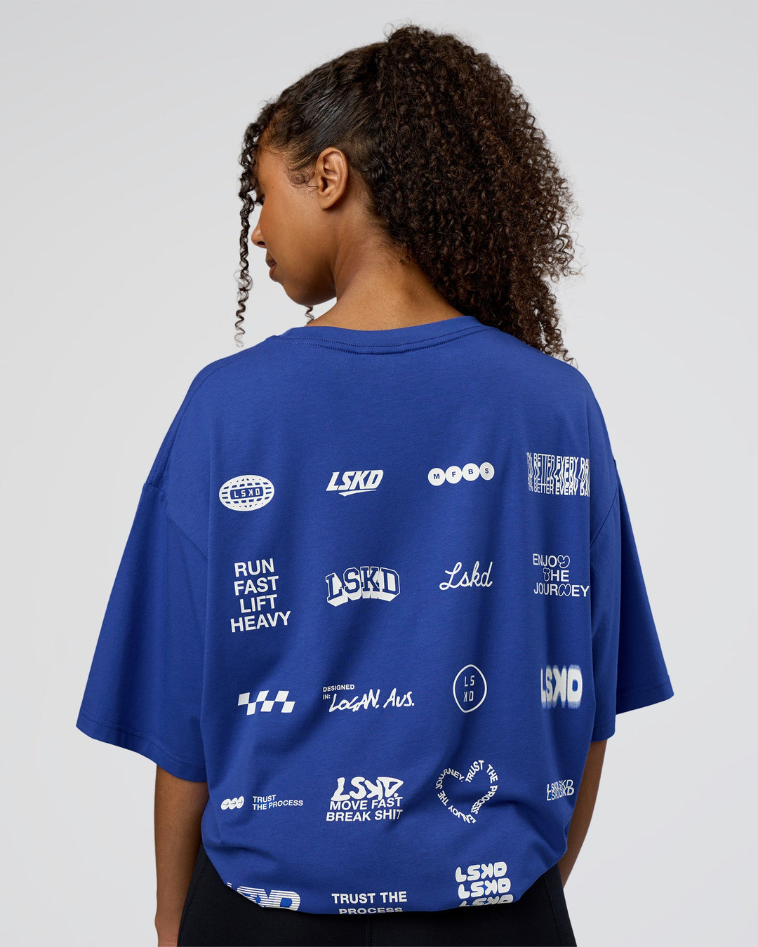 Woman wearing Grid FLXCotton Oversized Tee - Power Cobalt-White | Model:Jordan | Size:L