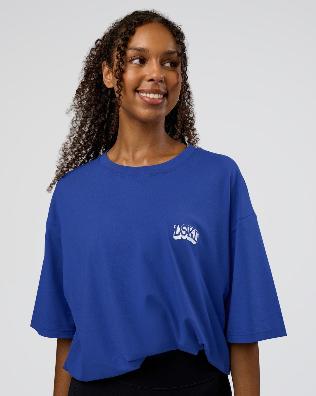 Woman wearing Grid FLXCotton Oversized Tee - Power Cobalt-White | Model:Jordan | Size:L