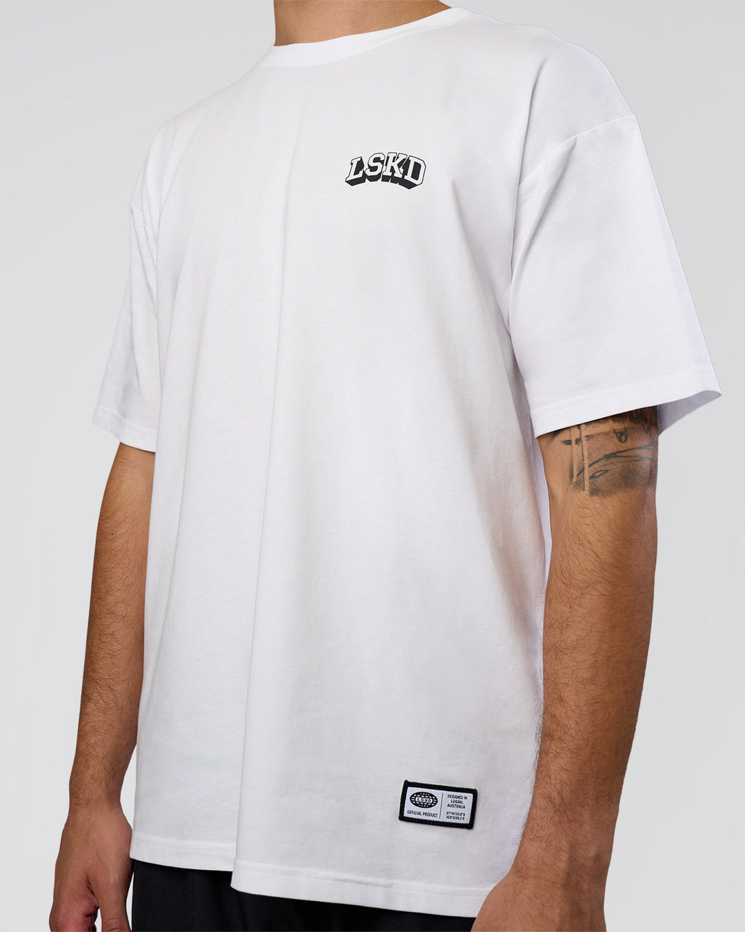 Man wearing Grid FLXCotton Oversized Tee - White-Black | Model:Zoran | Size:L