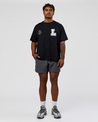 Man wearing Hype Heavyweight Unisex Oversized Tee - Black-White | Model:Xavier | Size:L