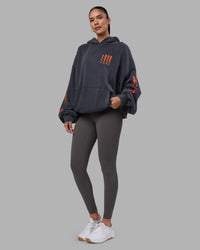 Woman wearing Journey Washed Unisex Oversize Hoodie - Black-Ultra Orange | Model:Rhiley | Size:L