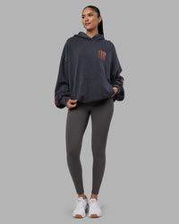Woman wearing Journey Washed Unisex Oversize Hoodie - Black-Ultra Orange | Model:Rhiley | Size:L