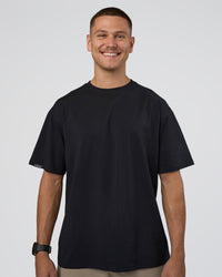 Man wearing Lifting Club FLXCotton Tee Oversize - Black-Black | Model:Nikola | Size:L