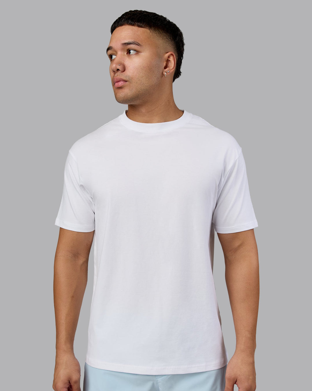 Man wearing Love The Run FLXCotton Tee Oversize - White-Dark Moss | Model:Kaelyb | Size:L