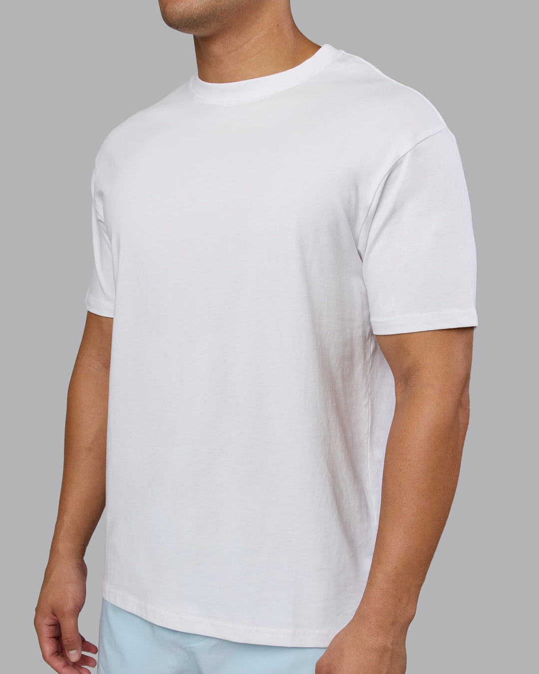 Man wearing Love The Run FLXCotton Tee Oversize - White-Dark Moss | Model:Kaelyb | Size:L