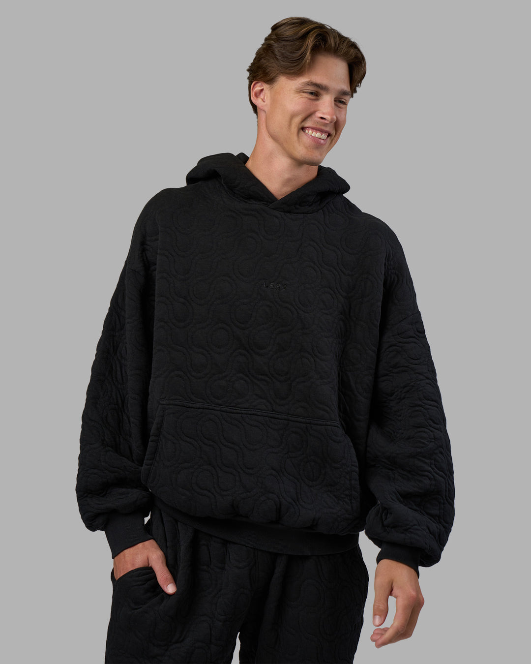 Man wearing MVP Quilted Oversized Hoodie - Black-Geometric | Model:Brandon | Size:L