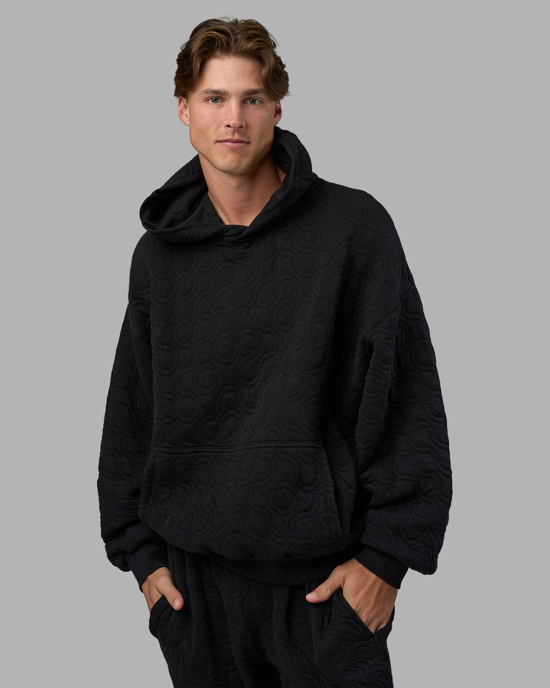 Man wearing MVP Quilted Oversized Hoodie - Black-Geometric | Model:Brandon | Size:L