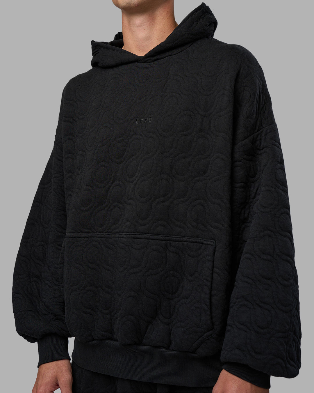 Man wearing MVP Quilted Oversized Hoodie - Black-Geometric | Model:Brandon | Size:L