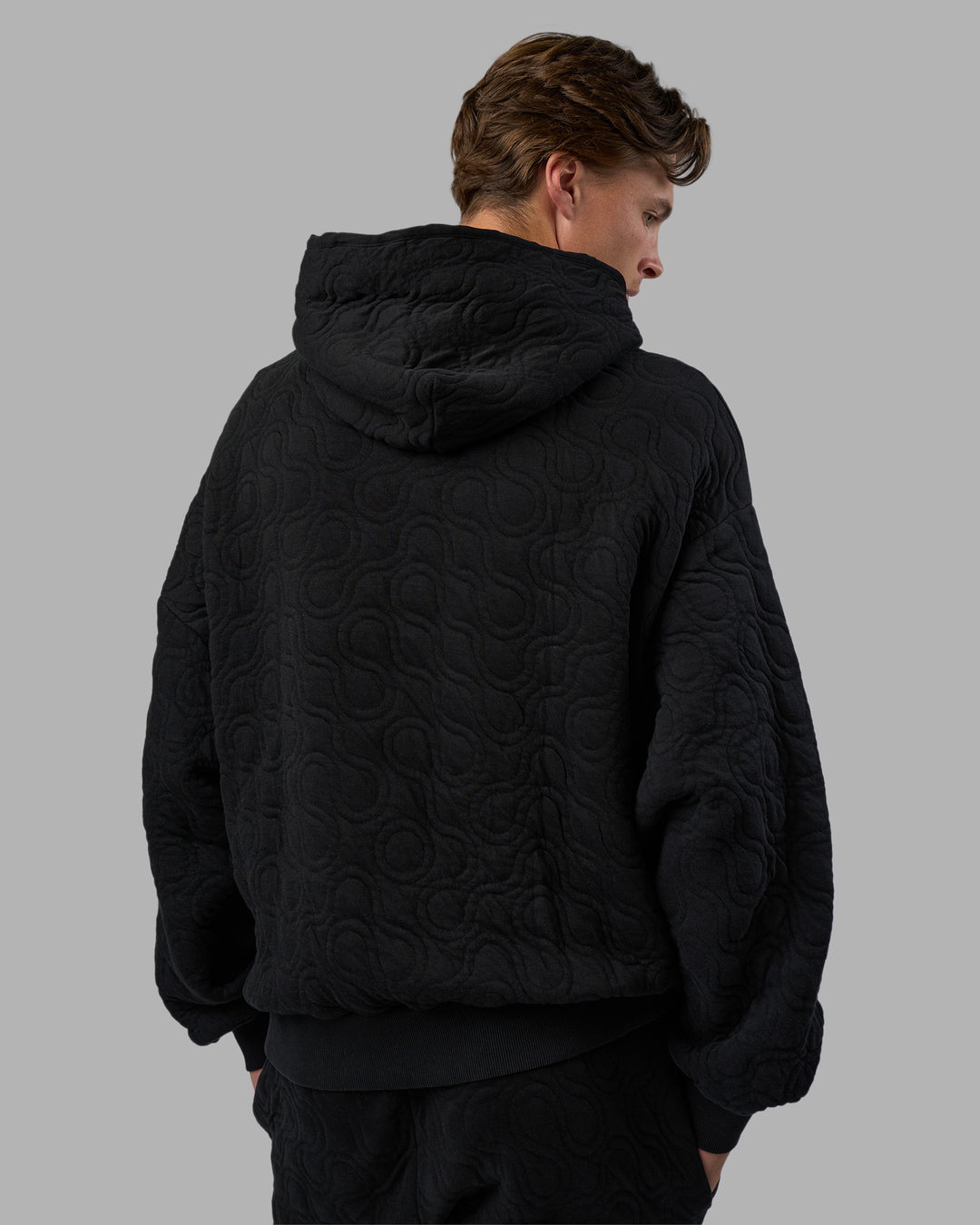 Man wearing MVP Quilted Oversized Hoodie - Black-Geometric | Model:Brandon | Size:L