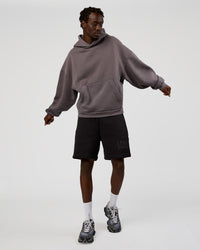 Man wearing Memory In Motion Heavyweight Fleece 7" Short - Black Washed | Model:Okello | Size:L
