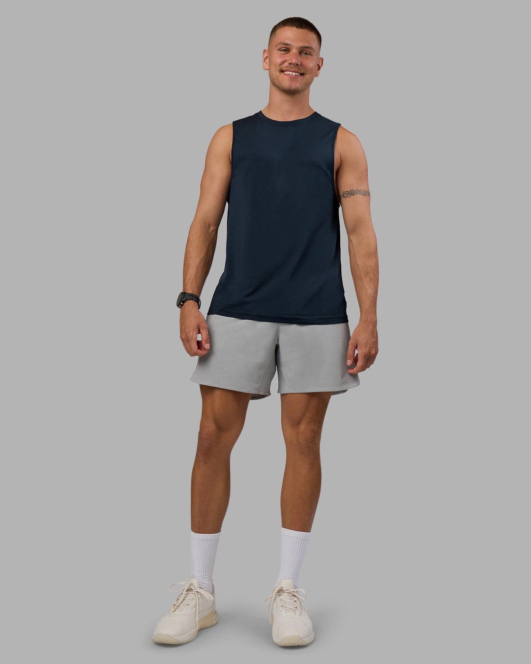 Man wearing AeroFLX+ Seamless Muscle Tank - Navy/Navy | Model:Nikola | Size:L