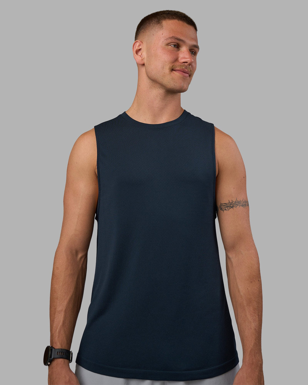 Man wearing AeroFLX+ Seamless Muscle Tank - Navy/Navy | Model:Nikola | Size:L