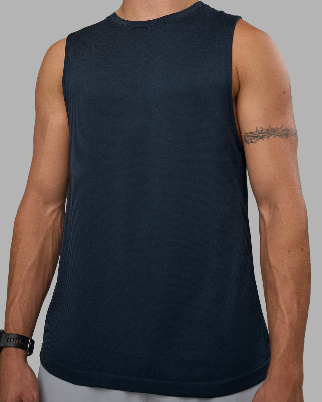 Man wearing AeroFLX+ Seamless Muscle Tank - Navy/Navy | Model:Nikola | Size:L