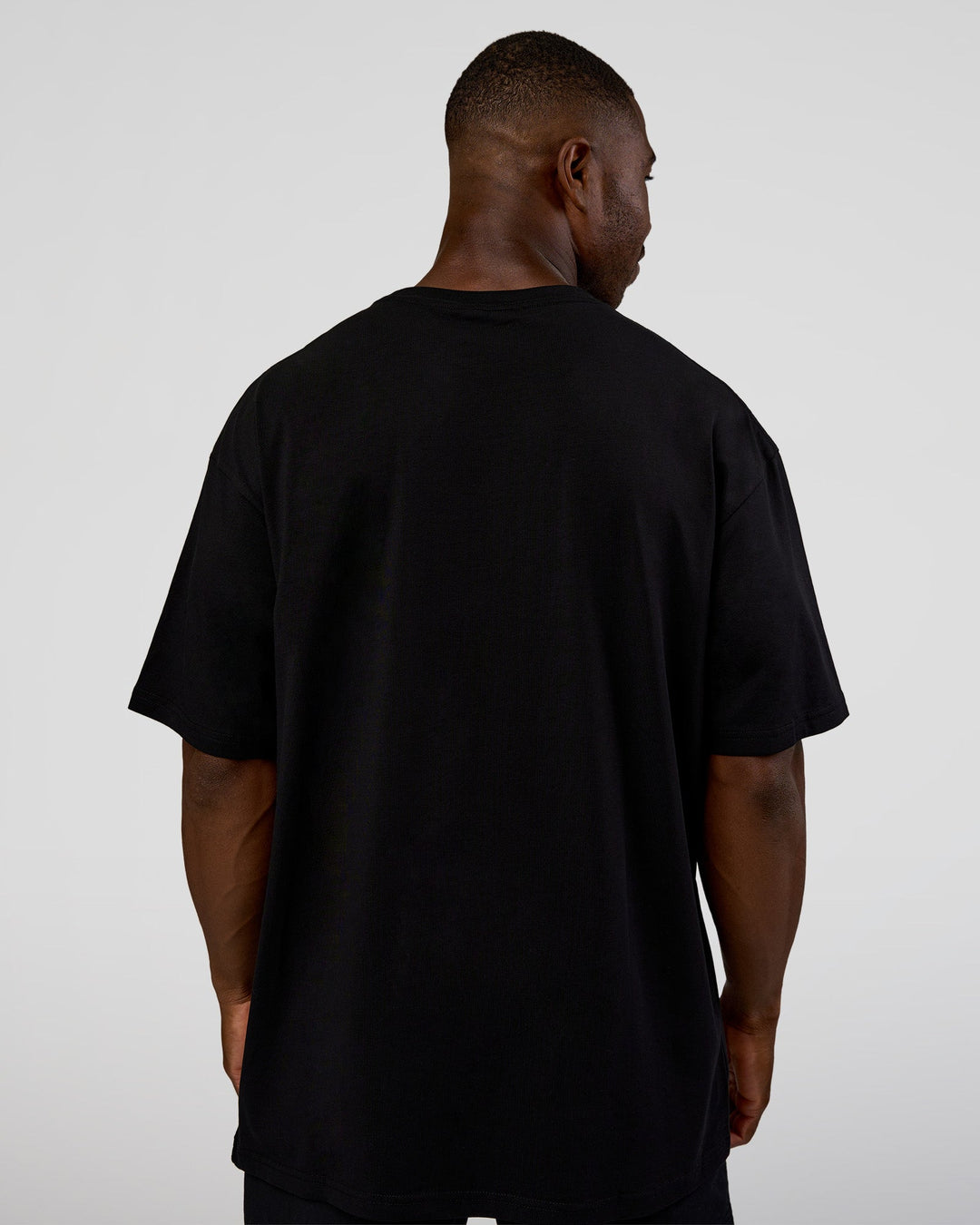 Man wearing Nothing Is Impossible FLXCotton Oversized Tee - Black-Flame | Model:Sam | Size:L