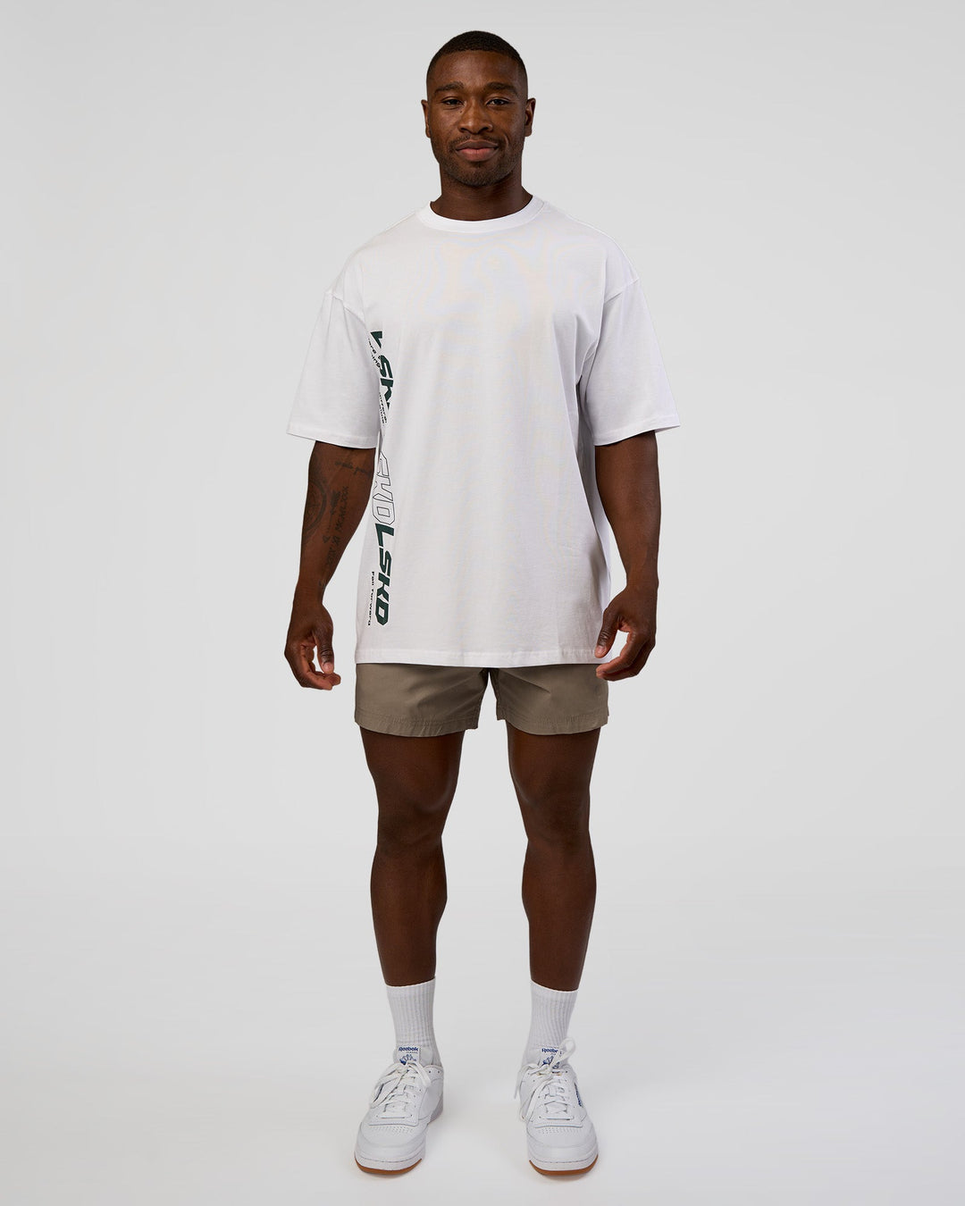 Man wearing Nothing Is Impossible FLXCotton Oversized Tee - White-Vital Green | Model:Sam | Size:L