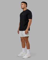 Man wearing On Repeat FLXCotton Oversized Tee - Black-White | Model:Kaelyb | Size:L