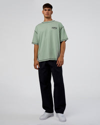 Man wearing Pressure is Privilege Oversized Tee - Iceberg Green-Black | Model:Jackson | Size:L