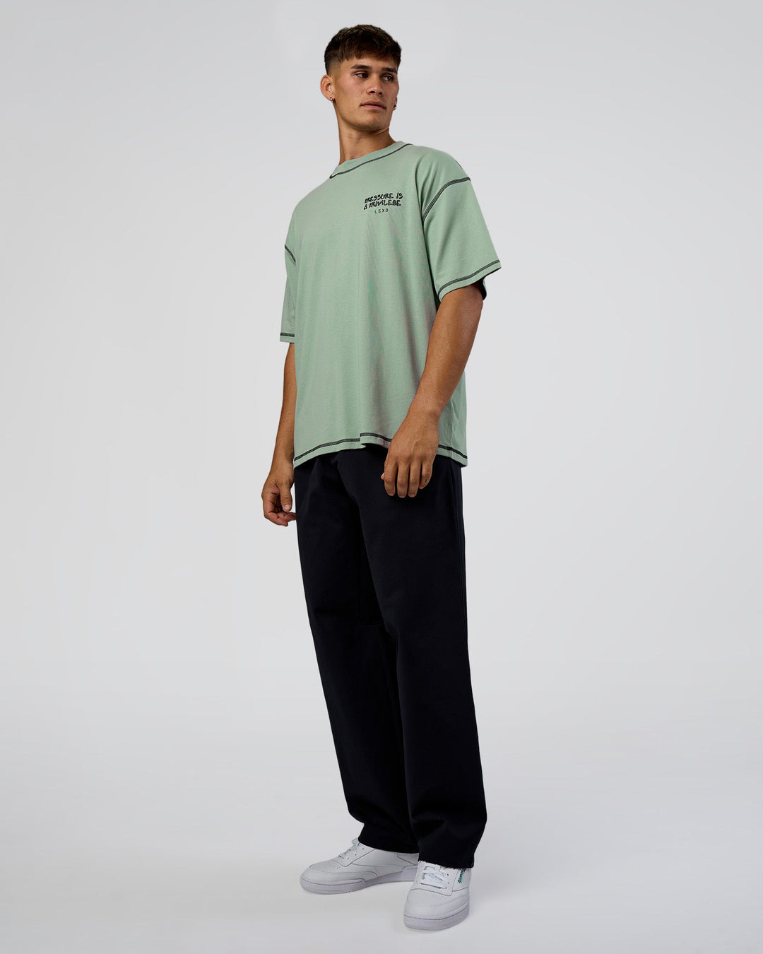 Man wearing Pressure is Privilege Oversized Tee - Iceberg Green-Black | Model:Jackson | Size:L