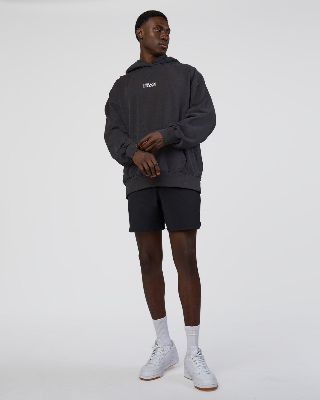 Man wearing Runner’s Unisex Oversized Hoodie - Black Washed-White | Model:Paabio | Size:L