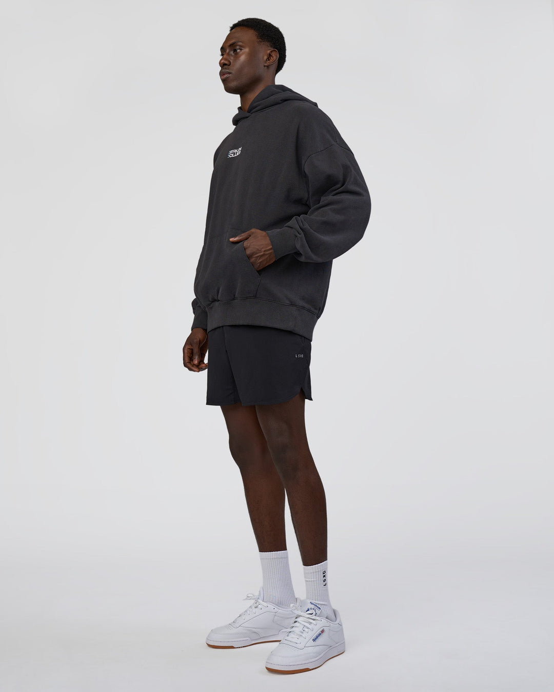 Man wearing Runner’s Unisex Oversized Hoodie - Black Washed-White | Model:Paabio | Size:L