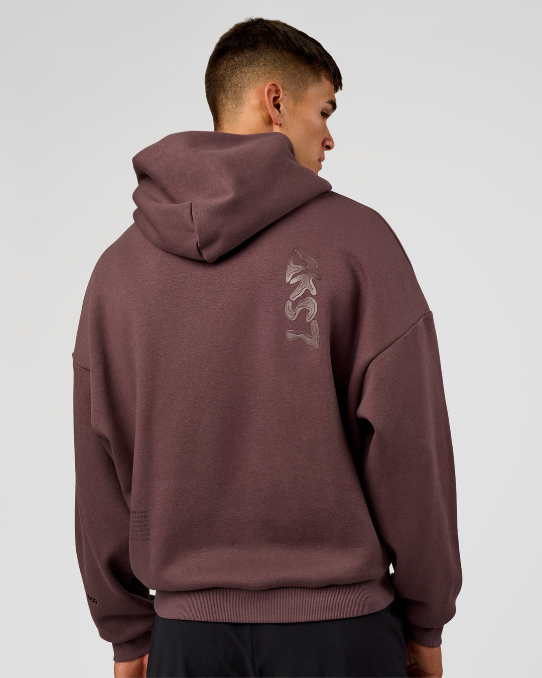Man wearing Static Grit Unisex Boxy Hoodie - Cocoa Powder-Hot Chocolate | Model:Jackson | Size:L