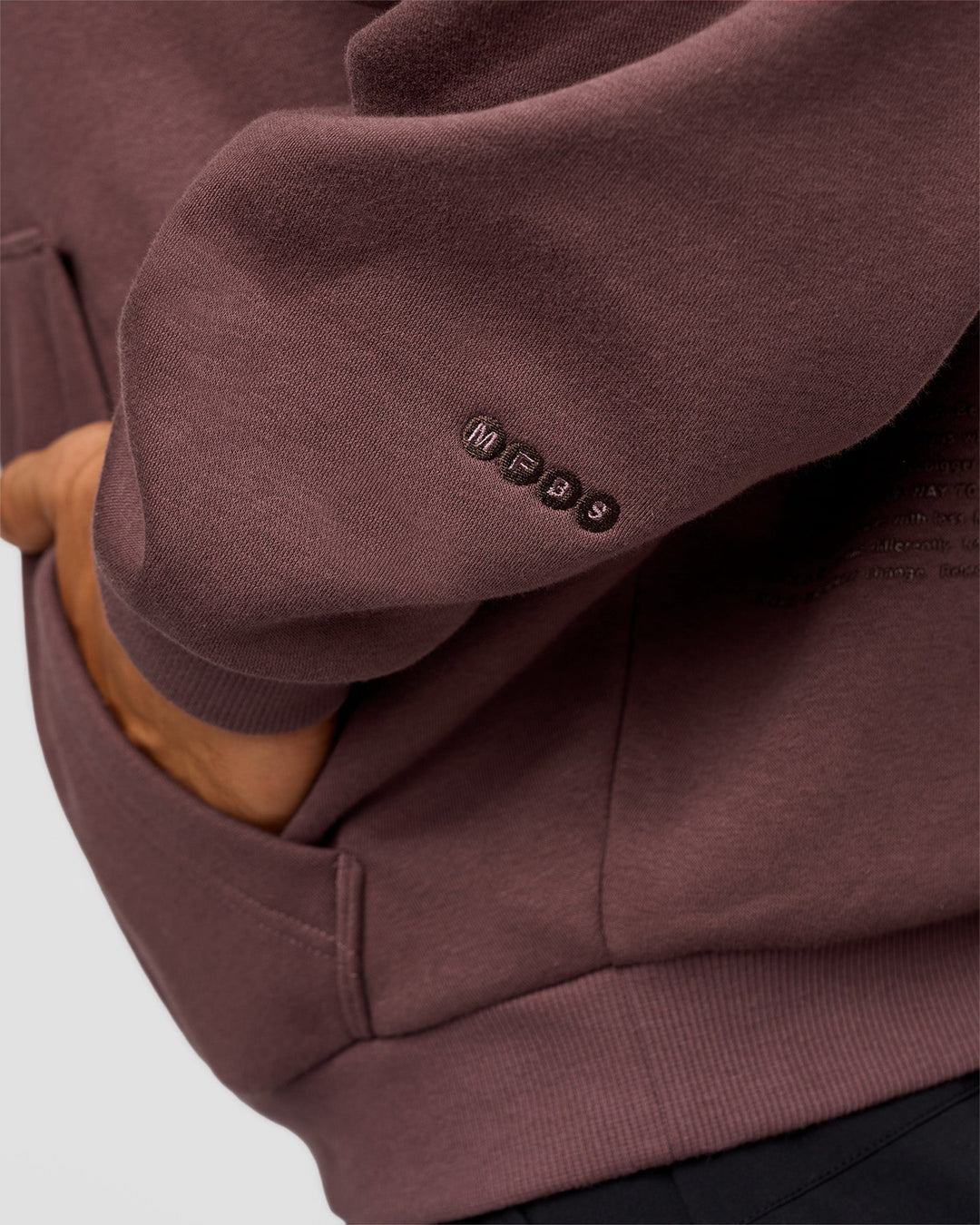 Man wearing Static Grit Unisex Boxy Hoodie - Cocoa Powder-Hot Chocolate | Model:Jackson | Size:L