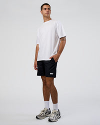 Man wearing Together We Rise FLXCotton Oversized Tee - White-Solar Lime | Model:Zoran | Size:L