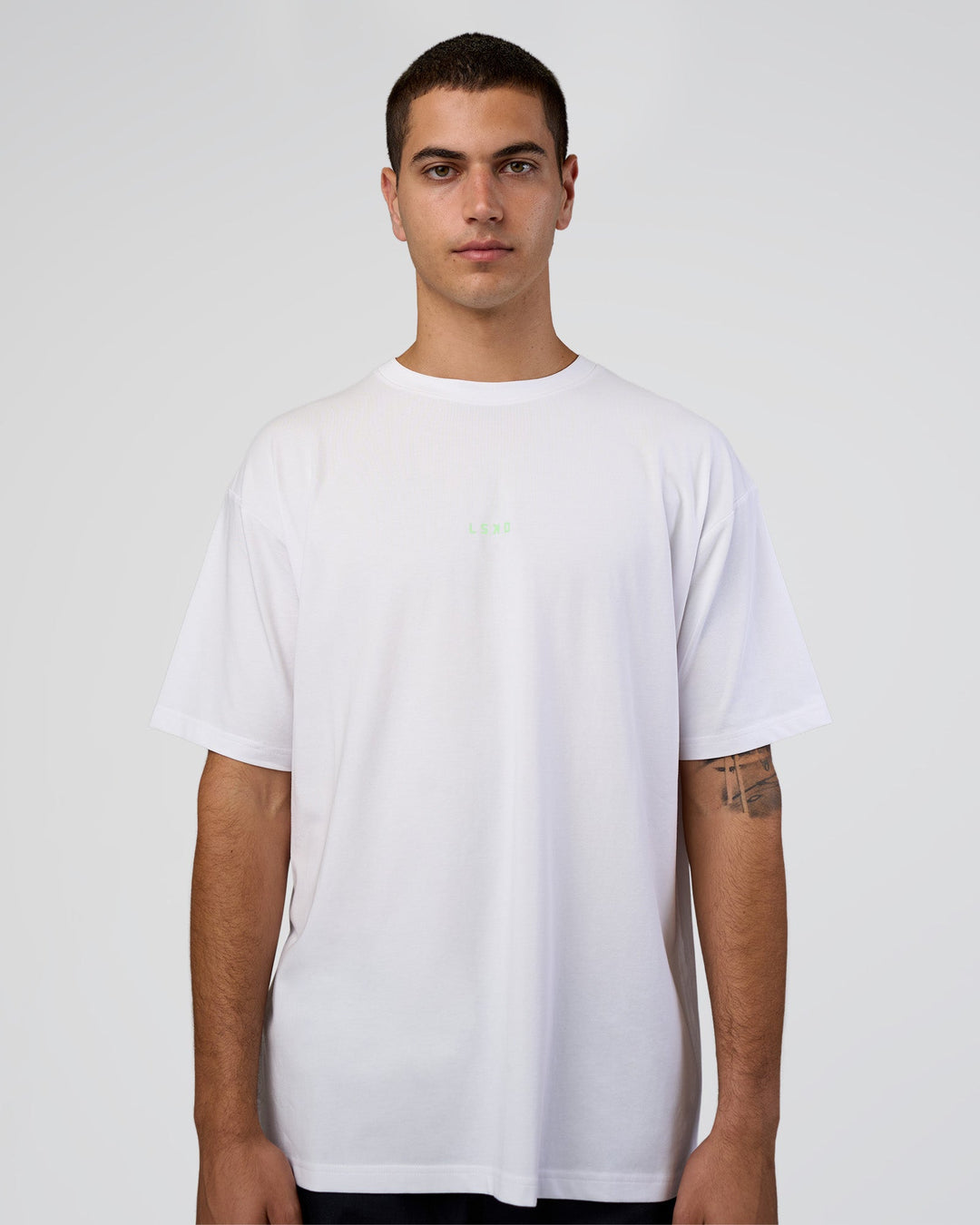 Man wearing Together We Rise FLXCotton Oversized Tee - White-Solar Lime | Model:Zoran | Size:L