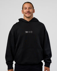 Man wearing Trust The Process Unisex Oversized Hoodie - Black-White | Model:Jaiden | Size:L