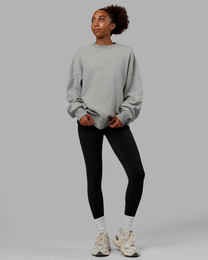 Woman wearing Unisex MVP Sweater Oversize - Light Grey Marl
