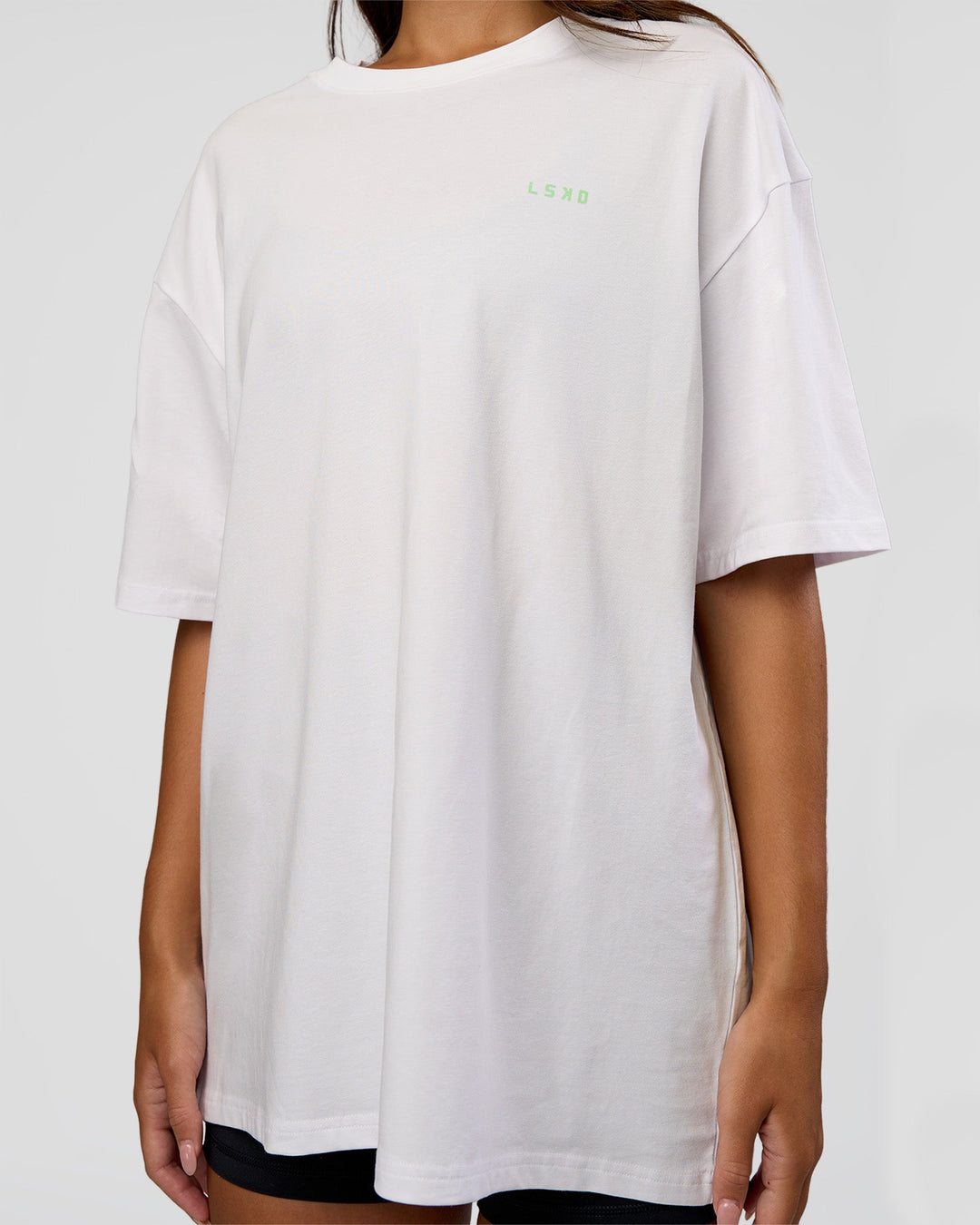 Woman wearing Unisex Strike Through FLXCotton Tee Oversize - White-Warm Apricot | Model:Kirstyn | Size:L