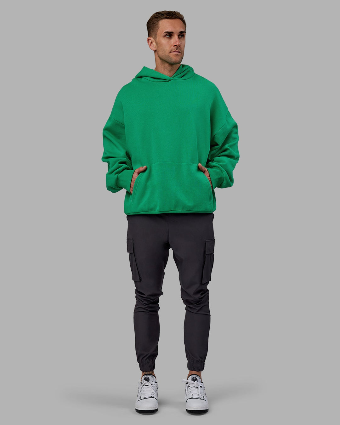 Man wearing Unisex We Rise Hoodie Oversize - Impact Green-White