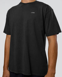 Man wearing We Love This  FLXCotton Oversized Tee - Black Washed-White | Model:Jackson | Size:L