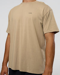 Man wearing We Love This  FLXCotton Oversized Tee - Greige Washed-Black | Model:Jackson | Size:L