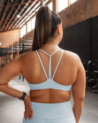 Woman wearing Agile Sports Bra - Skyride | Model:Gloria | Size:M