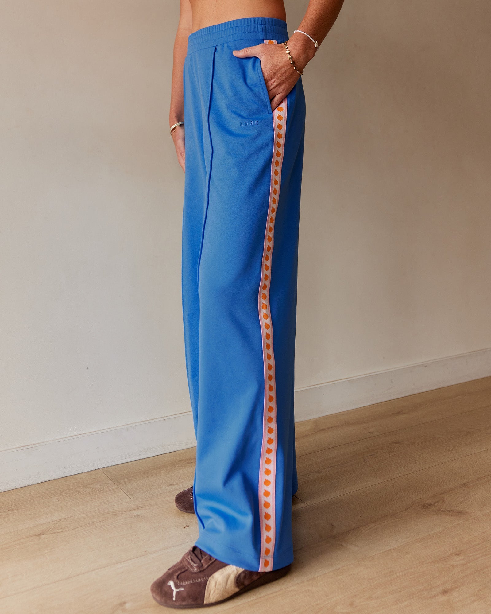 Woman wearing Peaches Track Pant - Palace Blue | Model:Dani | Size:M