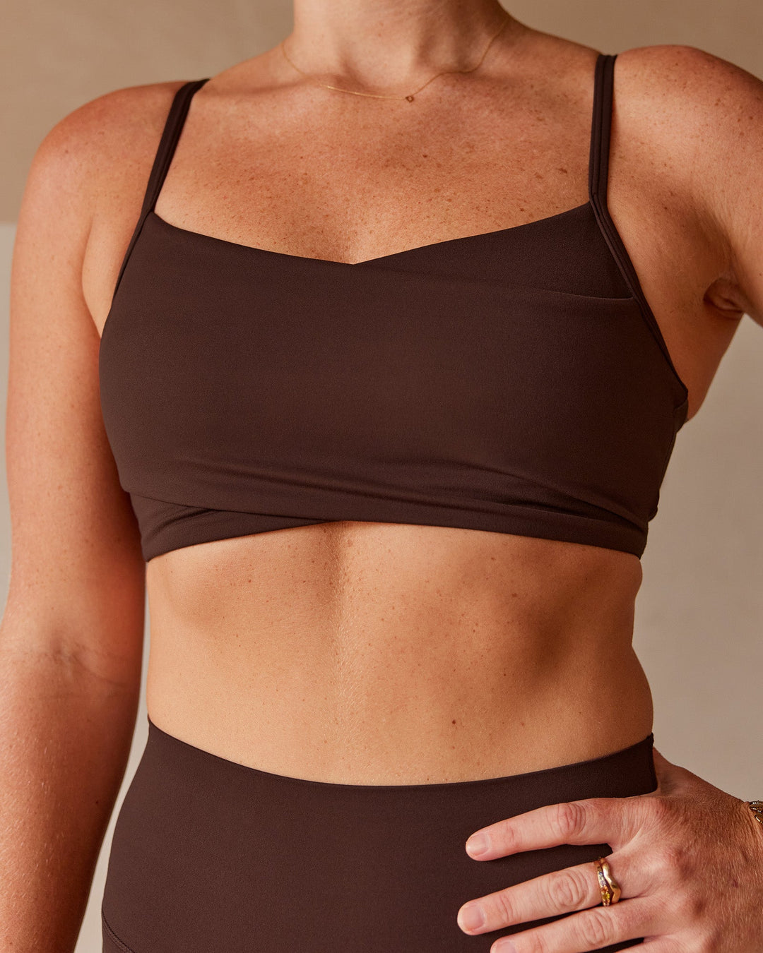 Woman wearing Peaches Wrap Sports Bra - Hot Chocolate | Model:Dani | Size:M