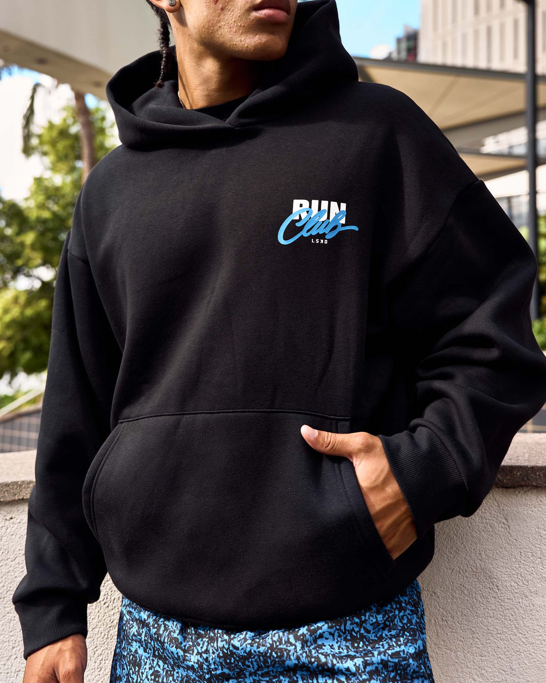 Man wearing Run Club Script Oversized Hoodie - Black-Palace Blue | Model:Malebo | Size:M