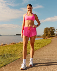 Woman wearing Velocity Sports Bra - Ultra Pink | Model:Phoebe | Size:M