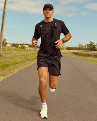 Woman wearing Pace Running Vest - Black-Reflective | Model:Jesse | Size:M/L