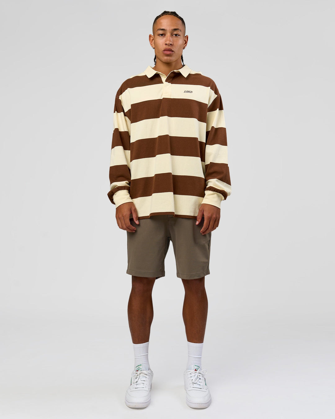 Man wearing Clubhouse Unisex Polo - Off White-Brown | Model:Malebo | Size:M